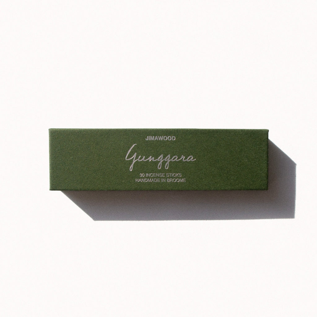 A green cardboard box on a plain background. Text on the box: Jimawood Gunggara 30 Incense Sticks Handmade in Broome