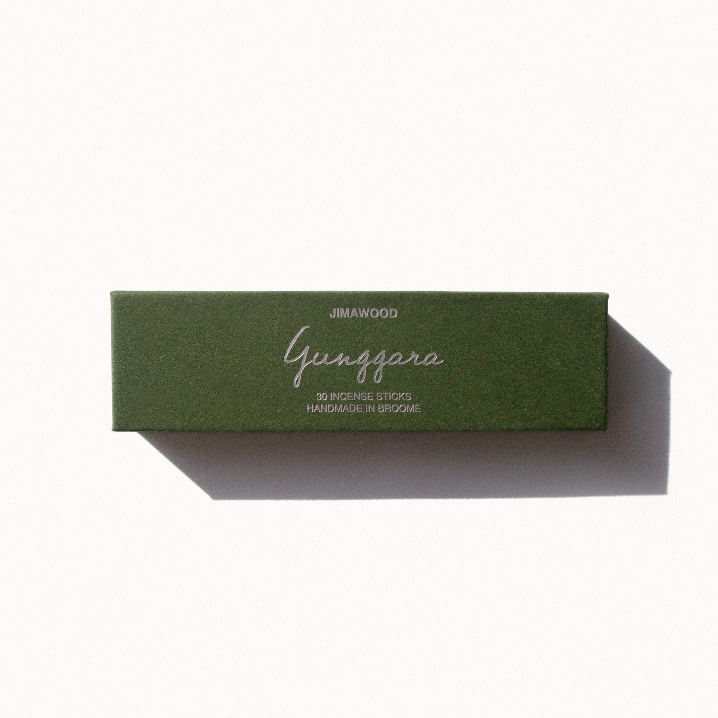 A green cardboard box on a plain background. Text on the box: Jimawood Gunggara 30 Incense Sticks Handmade in Broome