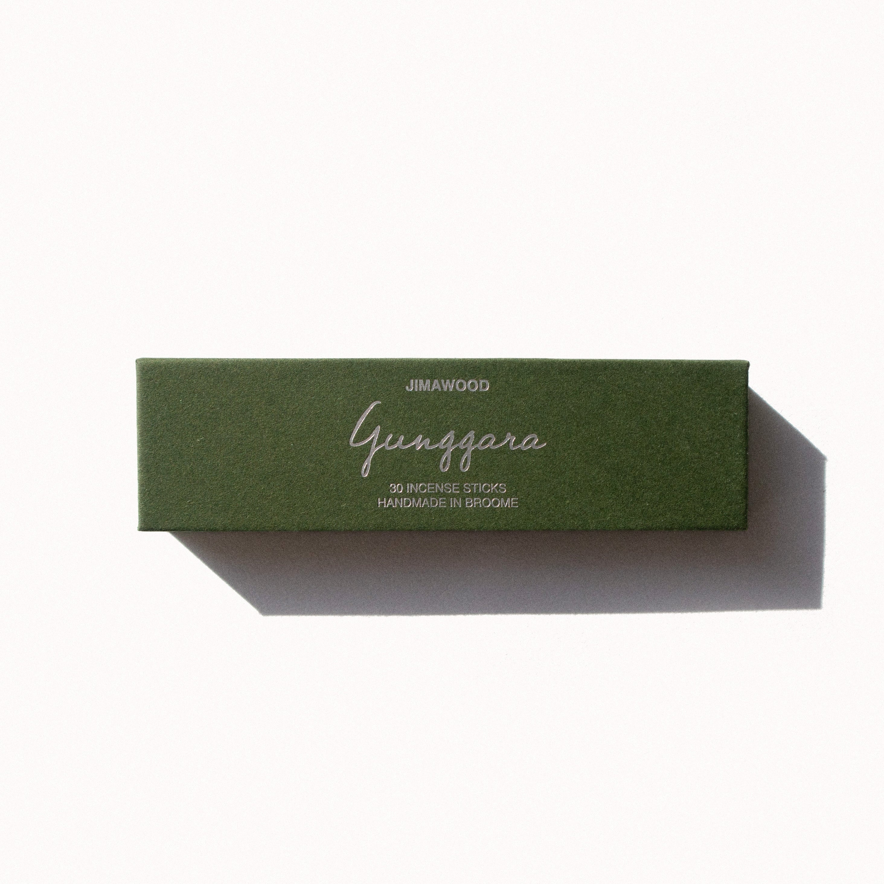 A green cardboard box on a plain background. Text on the box: Jimawood Gunggara 30 Incense Sticks Handmade in Broome
