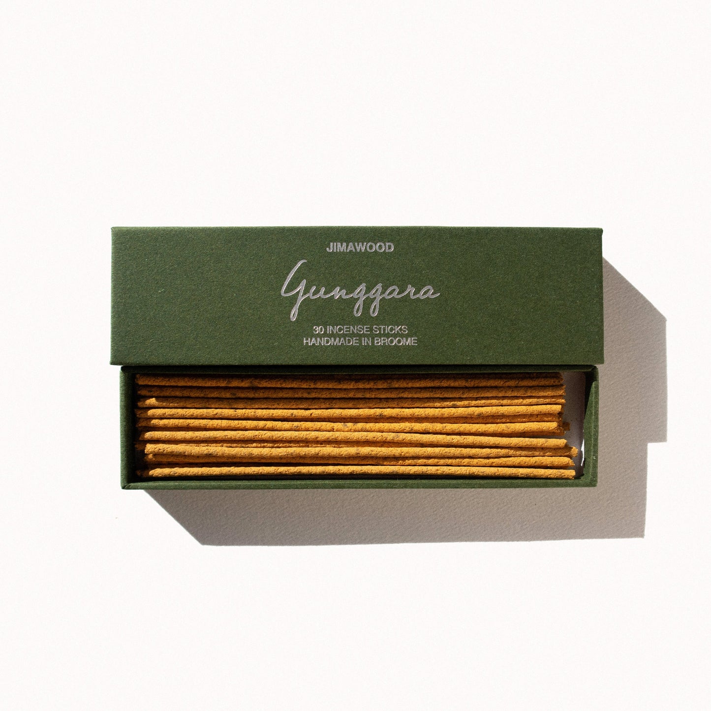 
                  
                    Two green cardboard boxes on a plain background. One box contains yellow incense sticks. The other one has text on the box: Jimawood Gunggara 30 Incense Sticks Handmade in Broome
                  
                